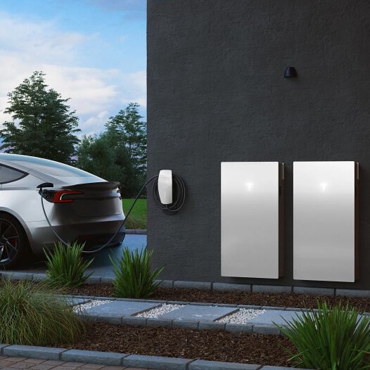 Tesla Wall Connector EV Charger installed on house and being used to charge a Tesla Model 3 electric car